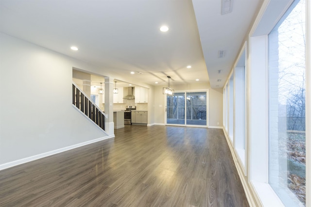 unfurnished living room with dark hardwood / wood-style flooring