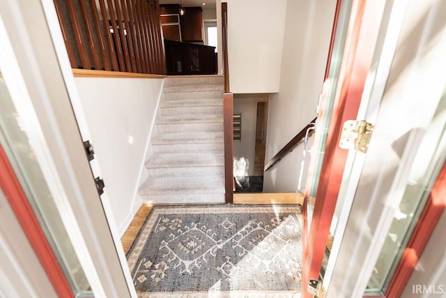 staircase with wood-type flooring