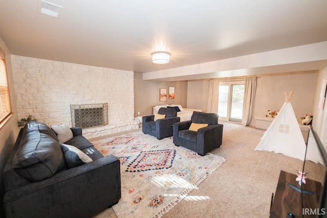 living room with light carpet and a fireplace