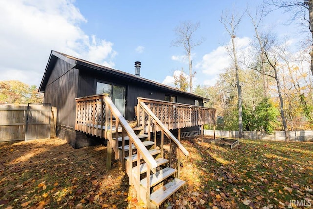 back of property featuring a wooden deck