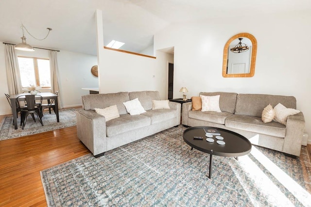 living room featuring hardwood / wood-style flooring and lofted ceiling