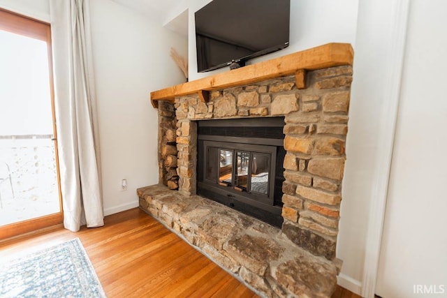 details with a fireplace and hardwood / wood-style flooring