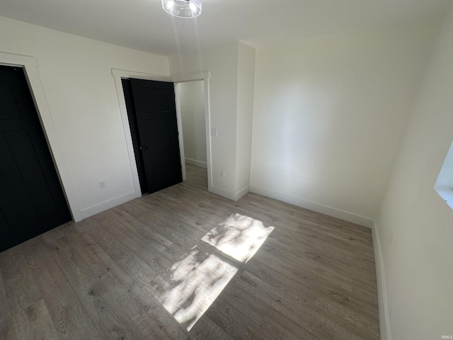 unfurnished bedroom with a closet and light hardwood / wood-style flooring