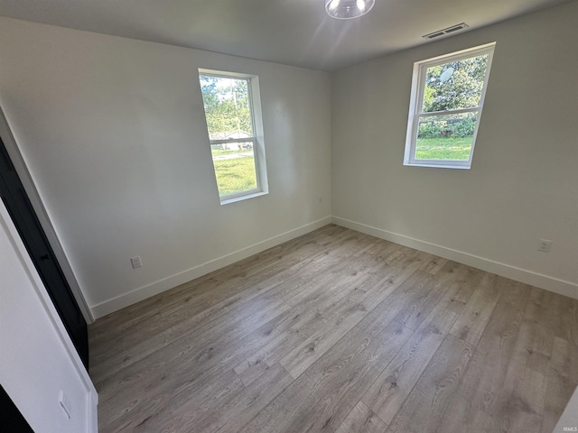 spare room featuring light wood-type flooring