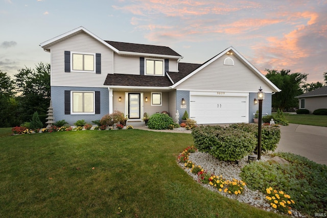 view of property featuring a garage and a lawn