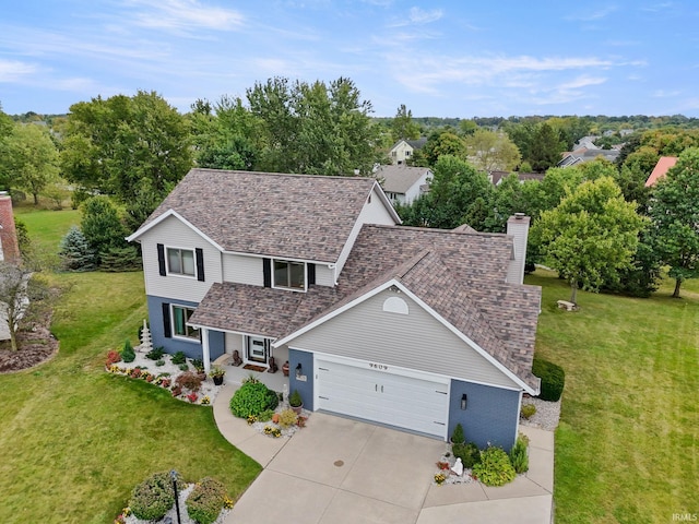 view of front of property with a garage and a front yard