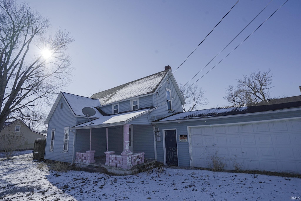 view of property featuring a porch and a garage