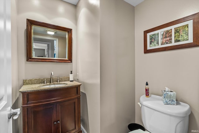 bathroom featuring toilet and vanity