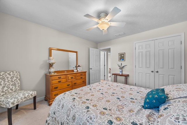 carpeted bedroom with a closet and ceiling fan