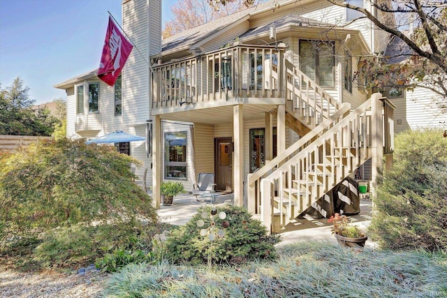 view of front of house with a deck and a patio area