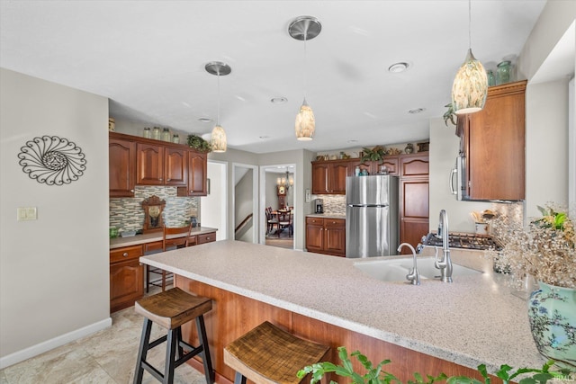 kitchen with a kitchen breakfast bar, appliances with stainless steel finishes, backsplash, and kitchen peninsula