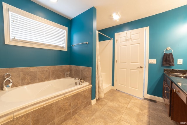 bathroom featuring tile patterned floors, vanity, and shower with separate bathtub