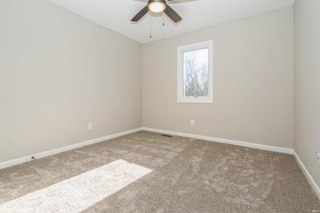 carpeted spare room with ceiling fan