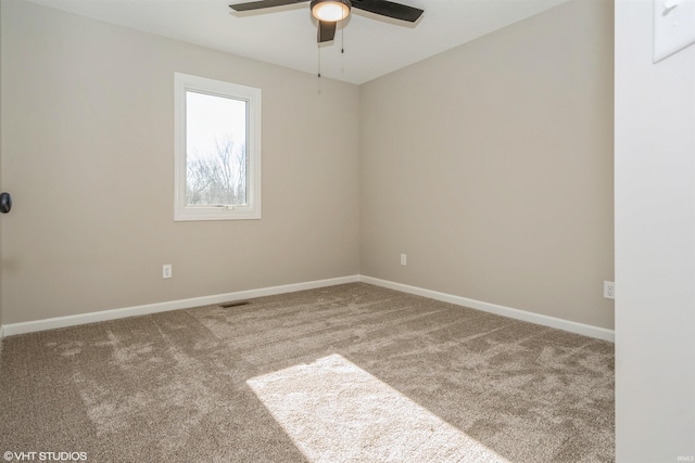 empty room featuring carpet floors and ceiling fan