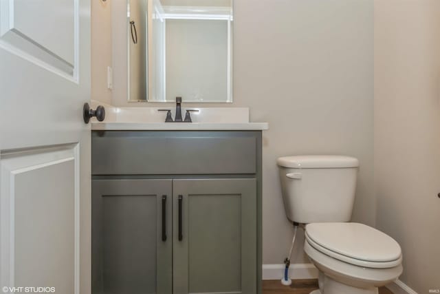 bathroom featuring toilet and vanity