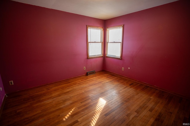 unfurnished room featuring hardwood / wood-style flooring