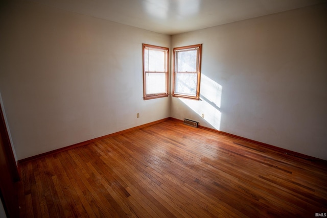 spare room with hardwood / wood-style flooring