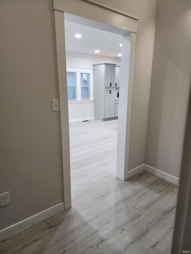 hallway with light hardwood / wood-style flooring