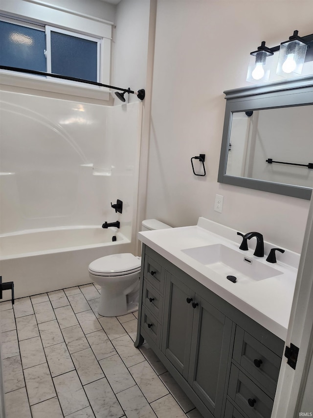 full bathroom featuring washtub / shower combination, toilet, vanity, and tile patterned flooring