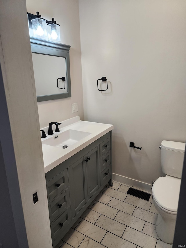 bathroom featuring toilet and vanity