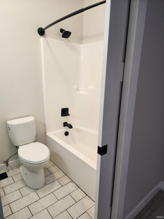 bathroom with toilet, tile patterned flooring, and bathtub / shower combination