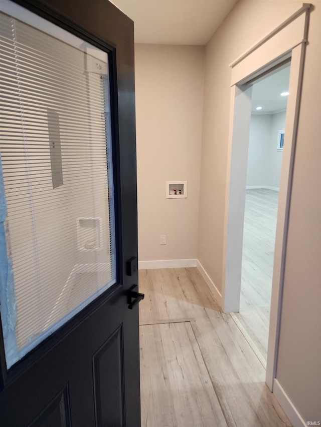 laundry area featuring washer hookup and light hardwood / wood-style floors