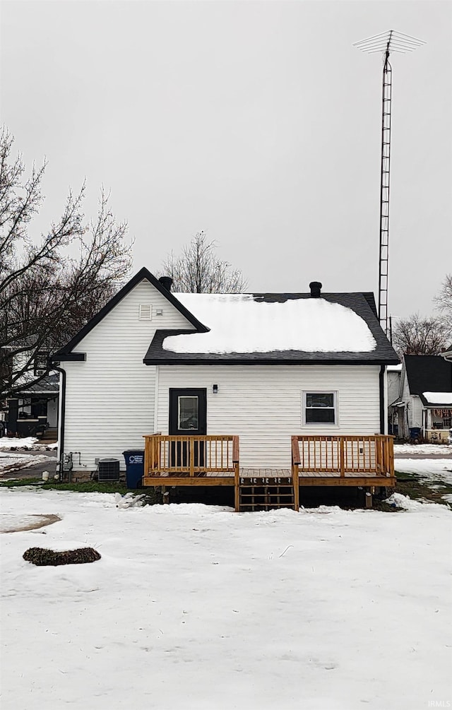 snow covered house featuring a wooden deck