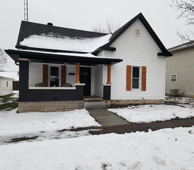 view of front facade with a porch and central air condition unit