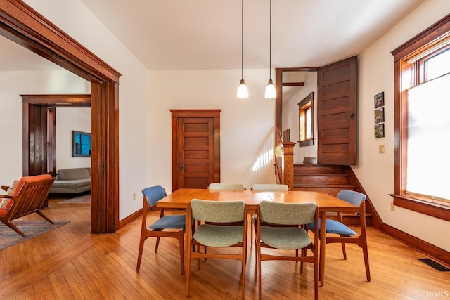 dining space with a healthy amount of sunlight and light hardwood / wood-style flooring