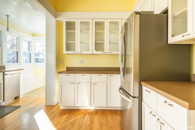 kitchen with white cabinetry, light hardwood / wood-style floors, dishwashing machine, and stainless steel fridge