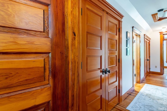 hall with light hardwood / wood-style floors