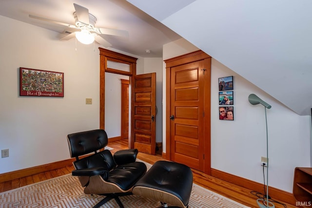 living area featuring ceiling fan, vaulted ceiling, and light hardwood / wood-style floors