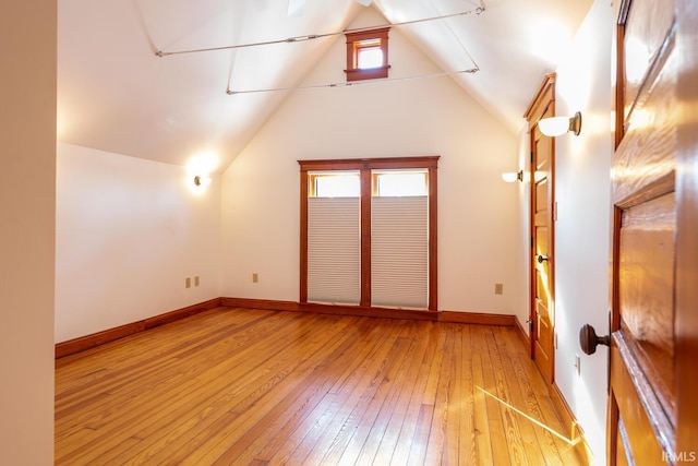 bonus room featuring vaulted ceiling and light hardwood / wood-style flooring