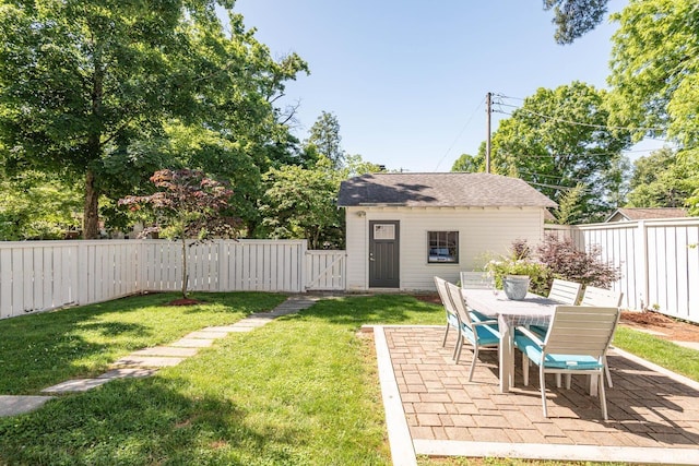 view of yard featuring an outbuilding and a patio