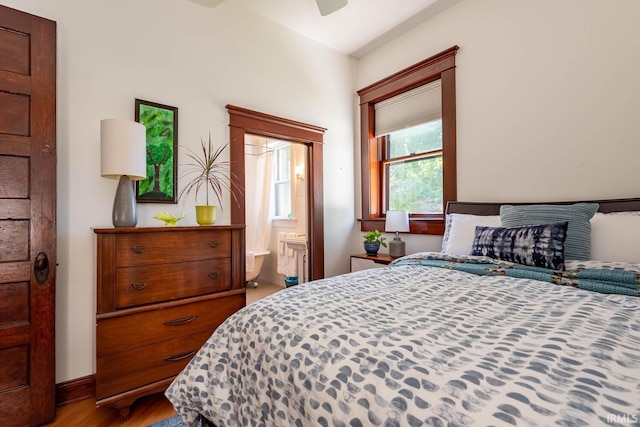 bedroom with light hardwood / wood-style flooring and ensuite bath