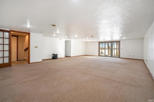 carpeted spare room featuring a textured ceiling