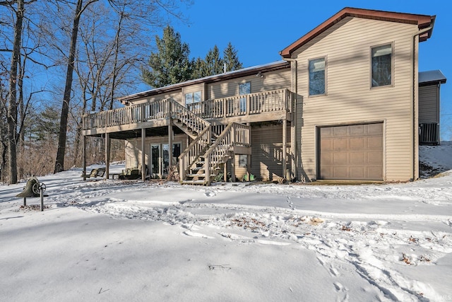 view of front of house featuring a garage, a deck, and cooling unit