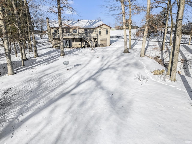 yard covered in snow featuring a wooden deck