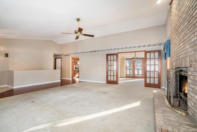 unfurnished living room featuring a brick fireplace, ceiling fan, lofted ceiling, french doors, and carpet flooring