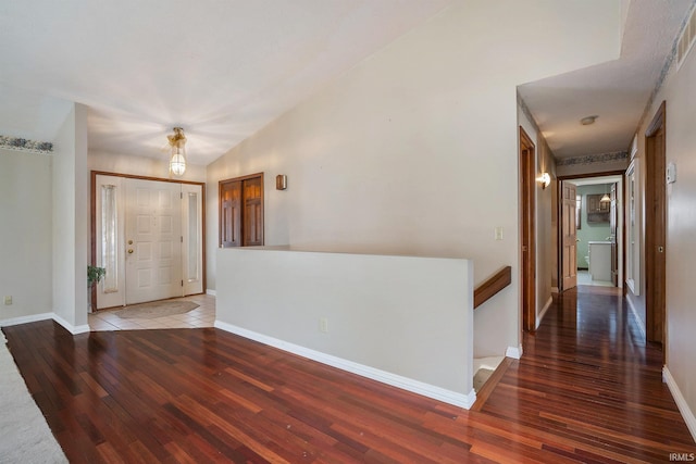 entryway with lofted ceiling and dark hardwood / wood-style floors