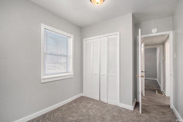 unfurnished bedroom with a closet and carpet