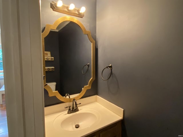 bathroom featuring toilet and vanity