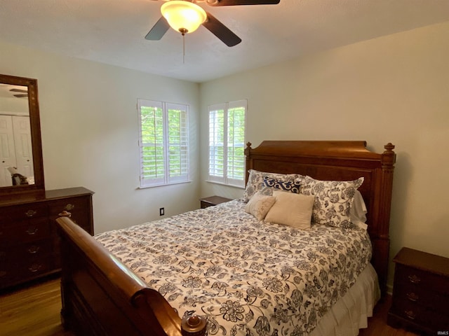 bedroom with ceiling fan and dark hardwood / wood-style flooring