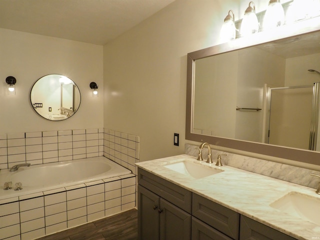 bathroom featuring vanity and shower with separate bathtub