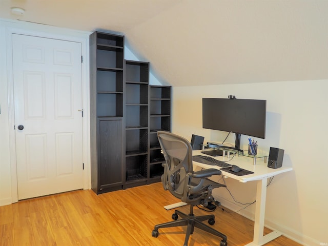 home office with lofted ceiling and wood-type flooring