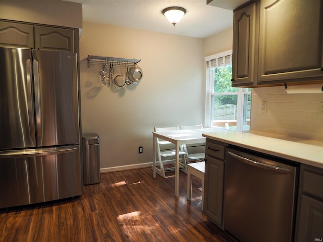 kitchen featuring appliances with stainless steel finishes, dark hardwood / wood-style floors, and tasteful backsplash