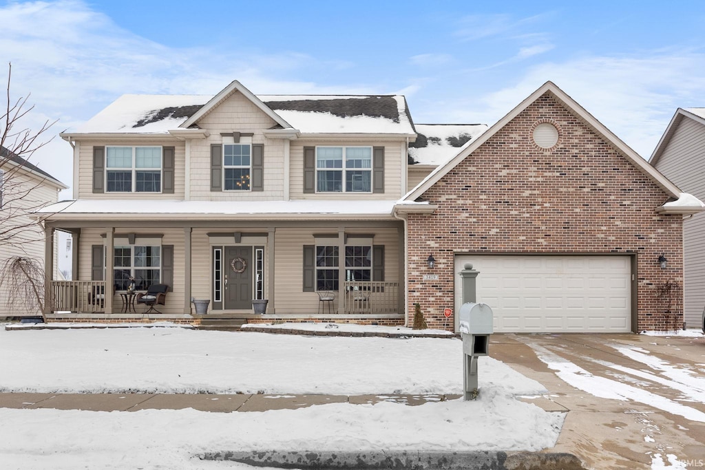 view of property featuring covered porch and a garage