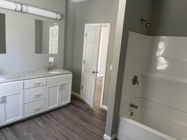 bathroom with shower / bath combination, vanity, and hardwood / wood-style floors