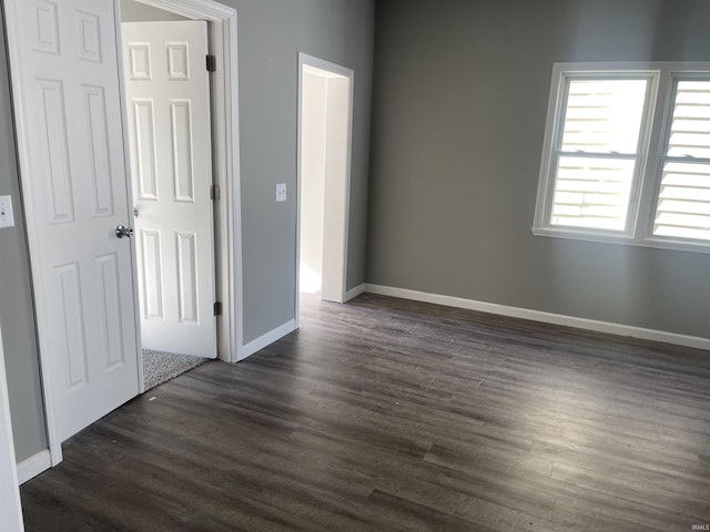 empty room featuring dark hardwood / wood-style flooring