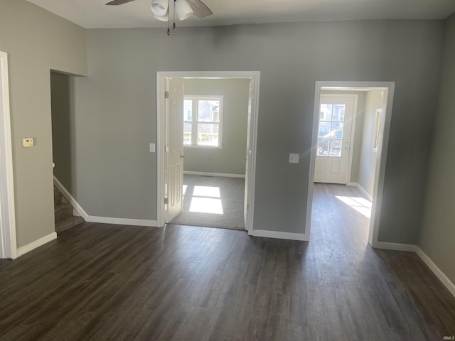 spare room featuring ceiling fan and dark wood-type flooring